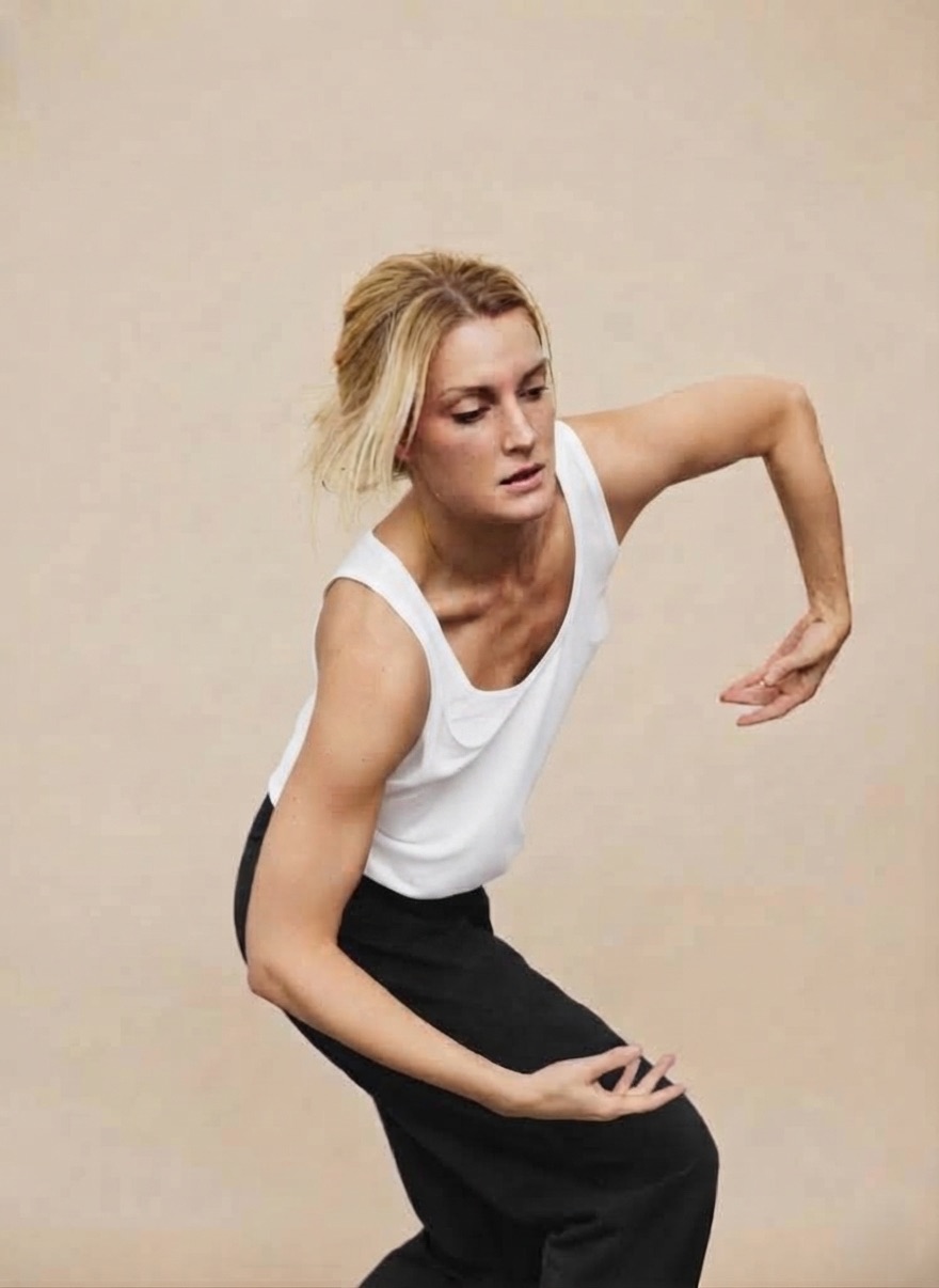 Sandra Olsson mid-movement in a white top and black trousers.